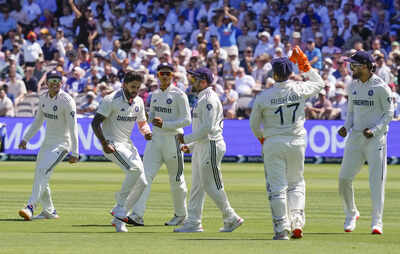 Nitish Kumar Reddy celebrates a wicket with teammates.