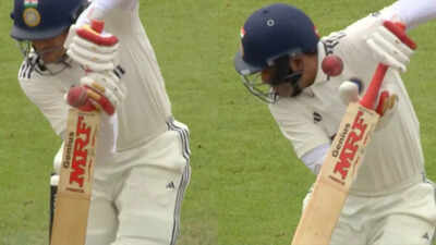 Shubman Gill reacts after being hit by a bouncer
