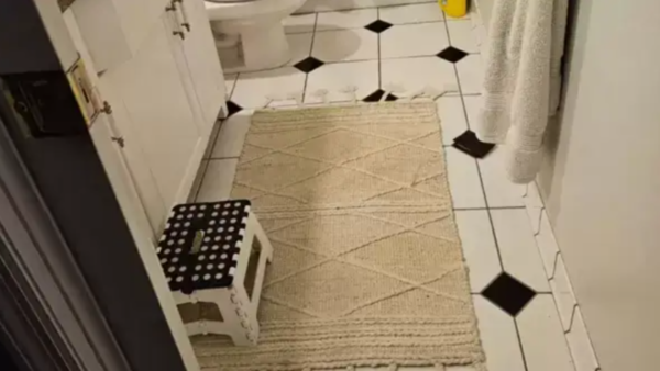 Close-up of the tiled floor with the cleverly hidden wallet.